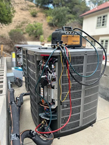 Precision One technician servicing an outdoor air conditioning unit